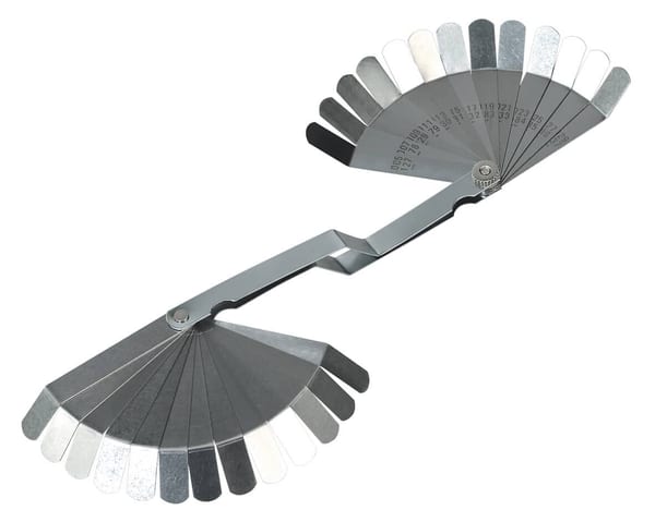 Feeler gauge with 26 blades, dual marked for precise measurements in metal work.