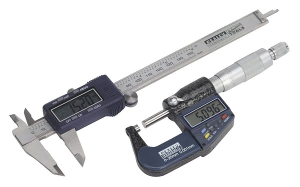 Digital Measuring Set 2pc: caliper and micrometer for precise measurements in machine shop work.