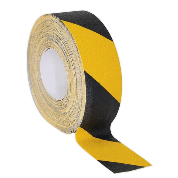 Black and yellow hazard tape roll for marking areas, featuring a bold striped pattern for visibility and safety in various applications.