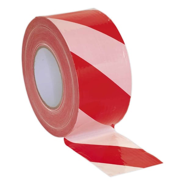 Red and white hazard warning tape roll for safety marking and barriers.