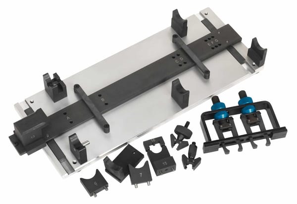Precision tooling fixture set with adjustable components for machining and assembly tasks, featuring various attachment pieces and a base plate.