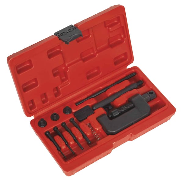 Motorcycle chain breaker and riveter tool set in a red case for garage use.