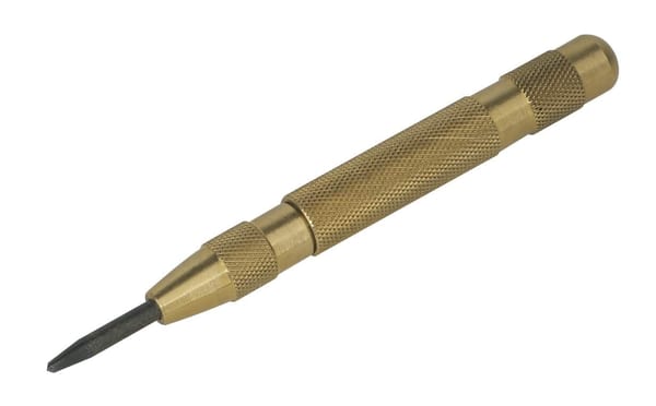 Automatic centre punch with a brass body and knurled grip for accuracy.