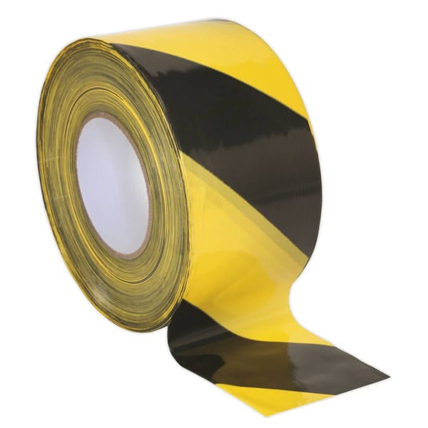 Yellow and black hazard tape roll for marking areas, featuring bold diagonal stripes for safety and visibility in various environments.