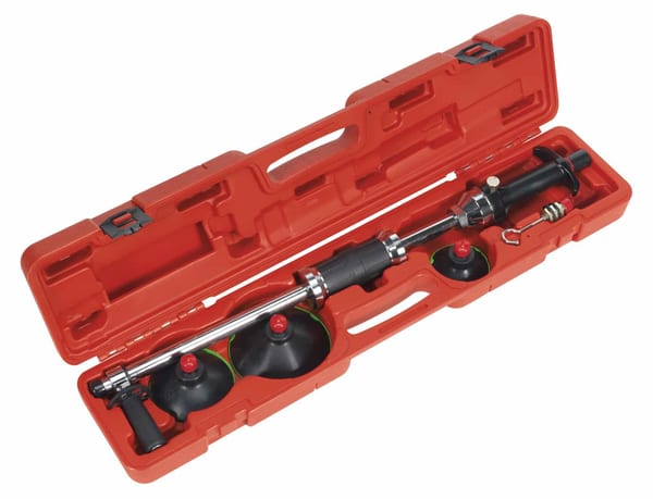 Air suction dent puller with plunger type design, in a red case.